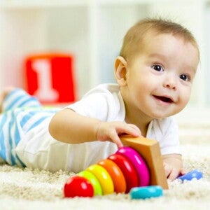 תינוק שוכב על גחונו ומשחק