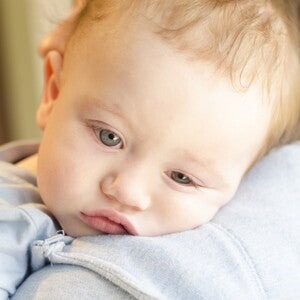 תינוק על הידיים עם מבט עצוב